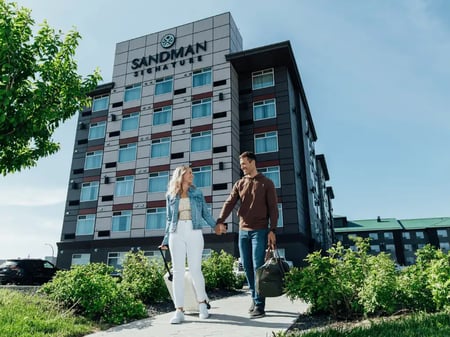 Couple leaving hotel hand-in-hand