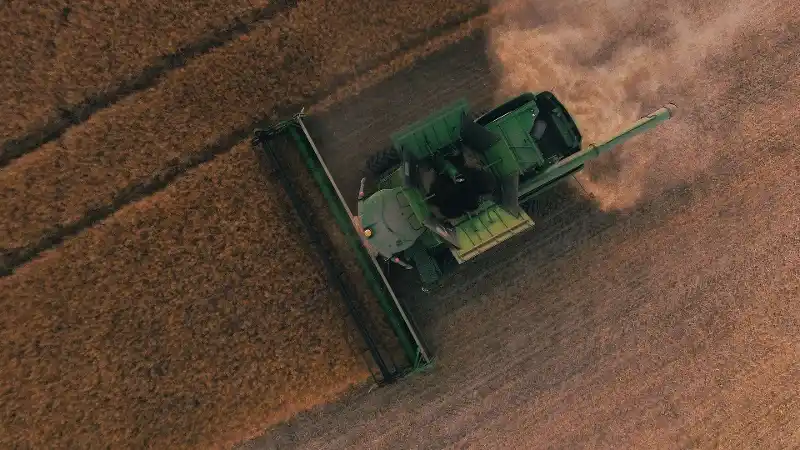 Tractor plowing through field