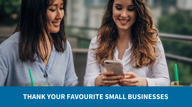 Two young women sitting at a cafe, smiling and writing a Thank You Note to their favourite local business as part of CFIB's Big Thank You Contest