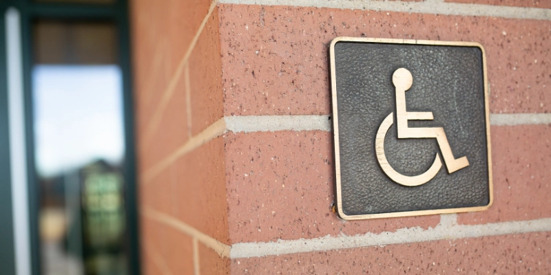 Wheelchair symbol on brick wall