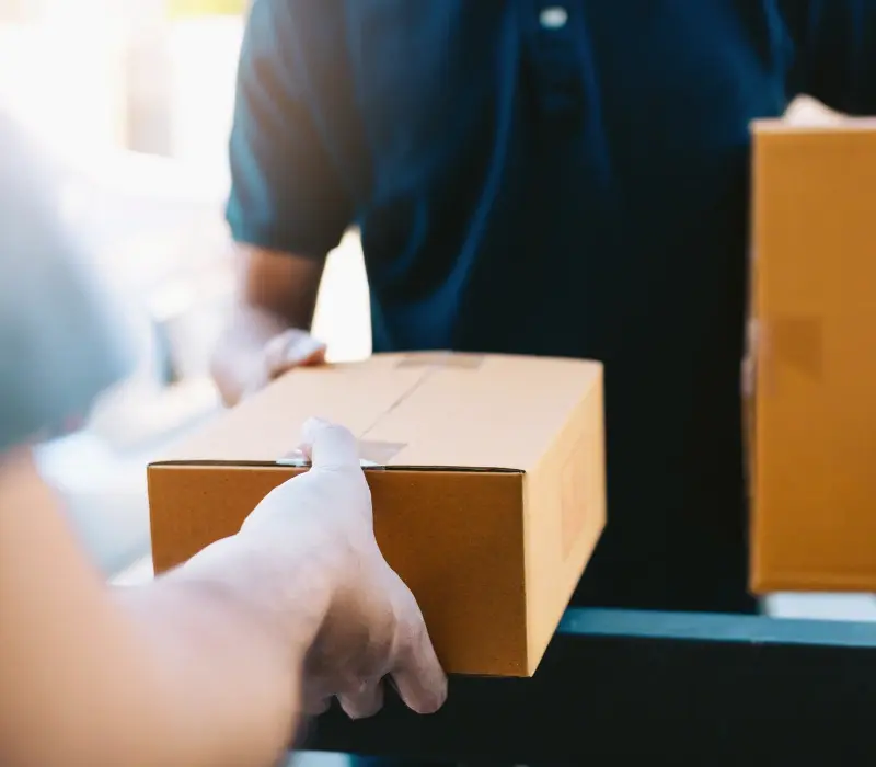 Delivery person delivering a package to a customer