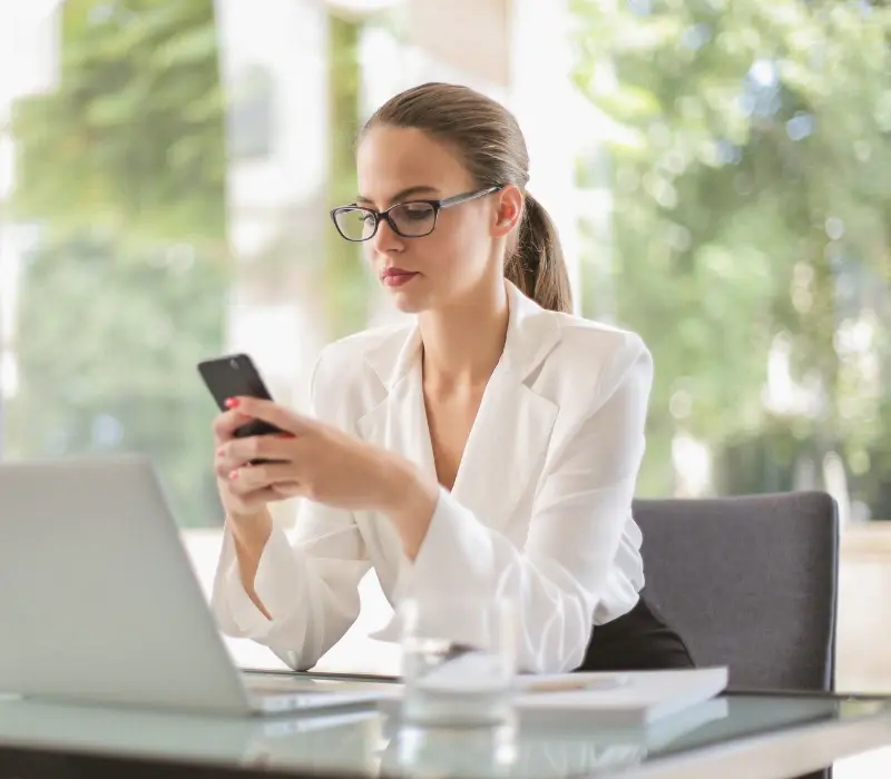 Businesswoman checking her cellphone