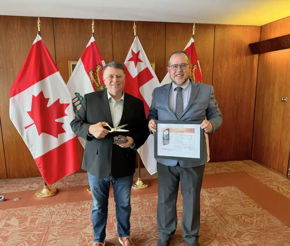 Prince Edward Island Premier Dennis King receives the Golden Scissors Award from CFIB senior policy analyst Frédéric Gionet