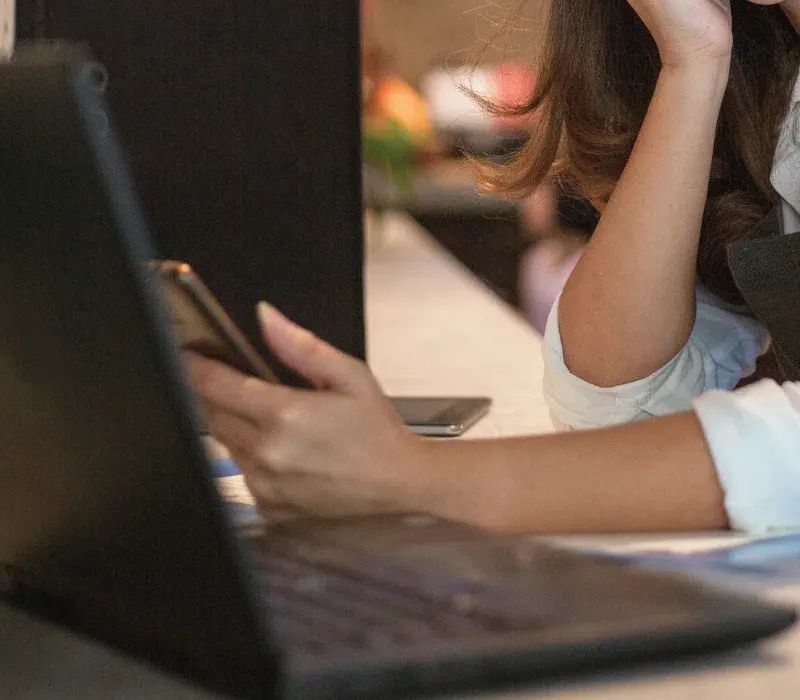 Small business owner looking at her cellphone