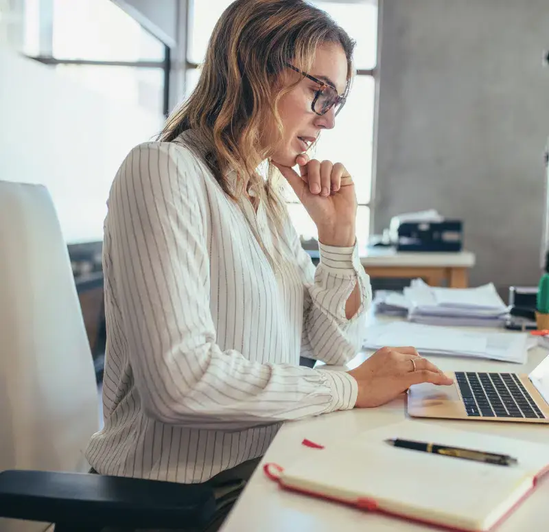 Small business owner looking at her laptop